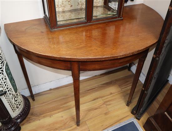 A pair of George III mahogany D shaped tables, W.114cm, D.60cm, H.76cm